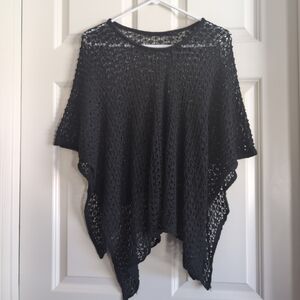 Black crochet or open knit sheer poncho with asymmetrical shark bite hem